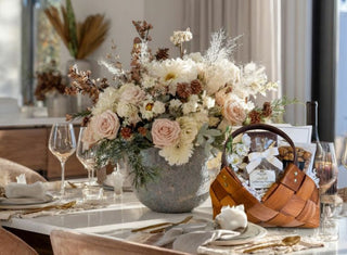 Luxury curated gift basket and elegant floral arrangement on a styled dining table from Biggest Little Baskets in Reno, Nevada