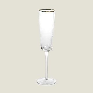 Product view of one 11.25-inch clear champagne flute with a gently triangular hammered bowl, slender stem, round foot, and fine gold rim.