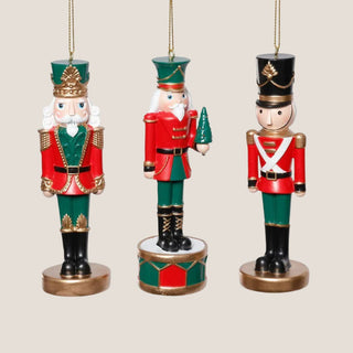 Three styles of 5-inch resin red and green nutcracker soldier ornaments with gold detailing - customers can choose their favorite traditional holiday ornament to compliment their Christmas Decor.