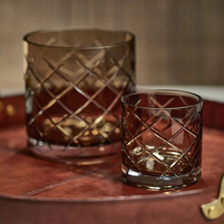 4-inch walnut-colored hand-cut glass vase or hurricane paired with the larger version resting on a dark leather tray— elegant multi-use décor accent for candlelight or florals by Biggest Little Baskets.
