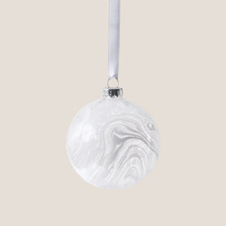 White watercolor glass ornament with satin ribbon and neutral background