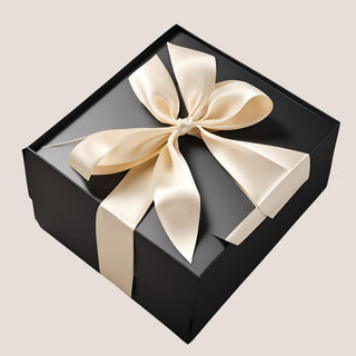 Closed matte black Elegant Noir keepsake gift box finished with a wide ivory satin ribbon tied in a full bow.