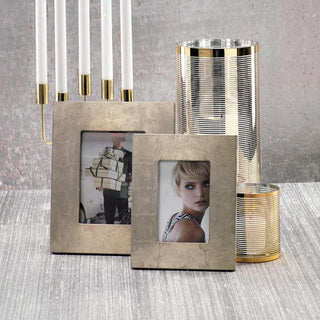 Elise 4x6 silver leaf photo frame styled with a coordinating larger frame, modern candleholder, and gold-striped glass accessories.