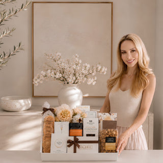 Mel Deakins, owner of Biggest Little Baskets, at a marble countertop with the Gathered Grace luxury gift box.