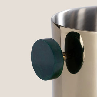 Up close of Gold ice bucket with deep green handles displayed on a neutral background