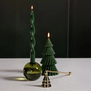 Gold candle snuffer with tree-shaped bell and twisted handle, elegant metal accessory for extinguishing candles with style.