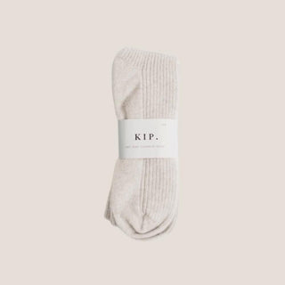 Ivory 100% cashmere sleep socks in a one-size design, a soft neutral gift for rest, travel, new mothers, or thank-yous.