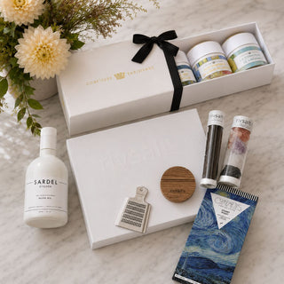 Jam Gogh culinary gift collection arranged on marble with RIVSALT set, Sardel olive oil, white balsamic, Van Gogh jam trio, and Starry Night chocolate.