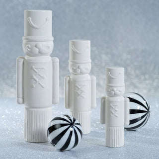 Set of matte white ceramic soldier figurines styled with black and white ornaments - Modern Christmas display.