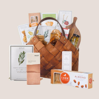 Medium Sized Classic Gourmet Charcuterie Gift Basket filled with delicious snacks and charcuterie items inculding sweet, savory, salty and umame flavors. Built in a brown woven basket with faux leather handles, this basket is the perfect gift for holidays, birthday, new home, a thank you gift or hostess gifts. This gift basket is a Reno, Nevada favorite! 