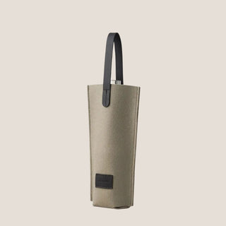 Angled product view showing the textured Merino wool body, black leather handles, and open top with a bottle inside for demonstration. Bottle not included.