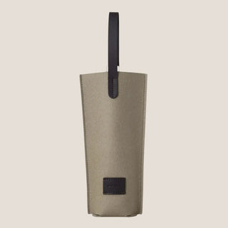 Front view of the Clay Black Merino Wool Bottle Bag, showing the clay-colored wool body, black leather handle, stitched edges, and front patch. Bag sold separately from any bottle.