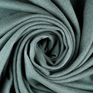 Close-up of Misty Mountain blue-green baby alpaca fabric arranged in spiral folds to show its woven texture.