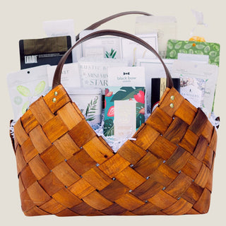 Front product view of the large brown woven Office Harmony basket filled with seasonal chocolates, crackers, cookies, tea, nuts, fruit, and savory pantry foods.