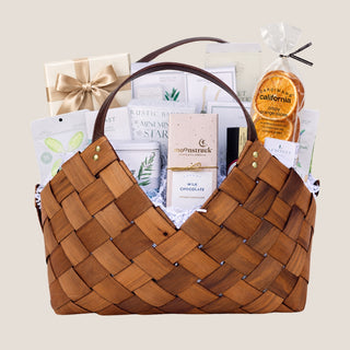 Front product view of the large brown woven Office Harmony basket filled with seasonal chocolates, crackers, cookies, tea, nuts, fruit, and savory pantry foods.