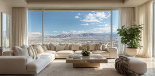 Modern living room with a large sectional sofa, coffee table, and scenic view of mountains in Reno Nevada. 