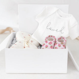 Gift-ready baby girl set with three practical infant essentials arranged by Biggest Little Baskets.