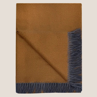 Folded bronze-brown Tapenade baby alpaca throw blanket with charcoal fringe and one corner turned back.