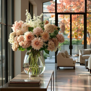 Bouquet of flowers in a clear vase on a table with a modern interior background