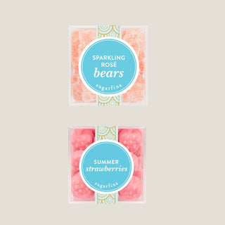 Two packages of sparkling rose bears and summer strawberries on a beige background