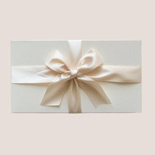 Closed matte white Petite Java Joy gift box tied with an ivory satin ribbon bow.