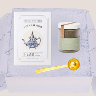 Open Petite Tea Indulgence Gift Box with Green Gold tea, shortbread cookies, and gold tea scoop in white gift fill.