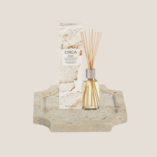 Sea Salt and Vanilla fragrance diffuser with marble-style box and glass reed diffuser shown with a small travertine stone tray for a new home gift box.