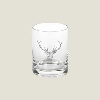 Front view of a clear glass tumbler with a detailed etched stag head and substantial base.