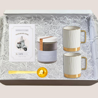 Open Tea Indulgence Gift Box with two porcelain mugs, Charles Grey tea, shortbread cookies, and gold scoop in white fill.