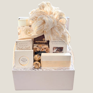Front view of the Large Offering gift box with an expanded assortment of artisan sweets, savory bites, chocolate, and candied almonds.