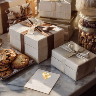 Luxury gift baskets Gift boxes with ribbons, cookies, and a card on a marble surface. Biggest little baskets in reno nevada