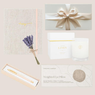 Mindful journal, lavender bouquet, signature pen, crisp white linen candle and weighted eye pillow arranged together.