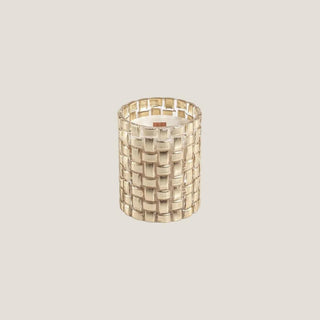Close product view of the Tonka Absolute candle in a dimensional braided gold glass vessel with a wood wick.