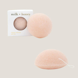 Milk + Honey pink clay konjac facial sponge shown with its box and two views of the soft rounded sponge.