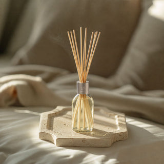 Sea Salt and Vanilla diffuser styled with a small travertine tray and gift box for the Welcome Home New Home Gift Box Level 1.