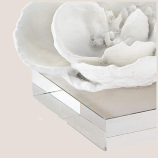 Close-up of layered white magnolia resin petals and textured center above the clear crystal base.