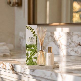 White Tea and Wild Mint fragrance diffuser styled with a small travertine stone tray in a bathroom setting for a new home gift box scent option.